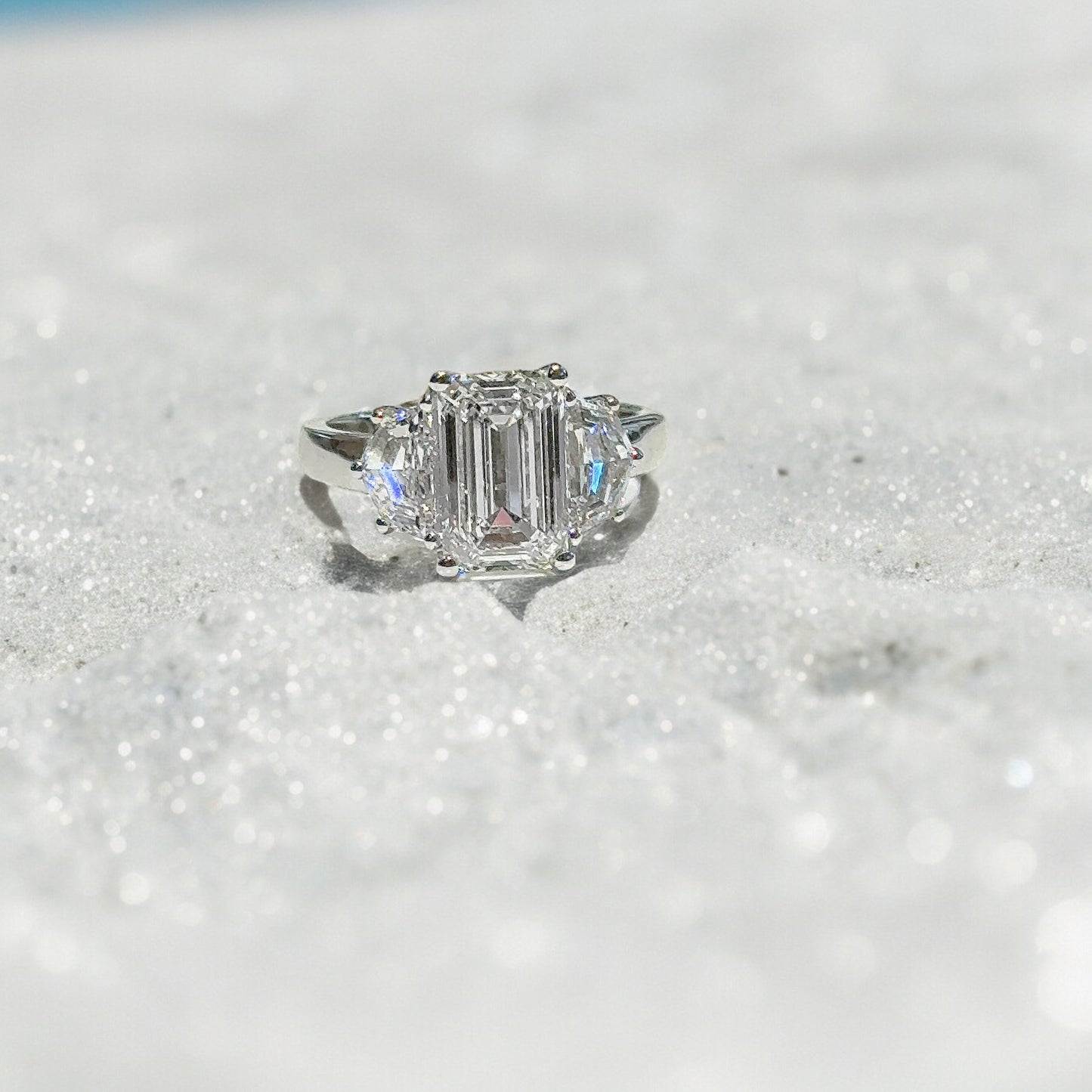 3.03 CT EMERALD CUT THREE STONE RING