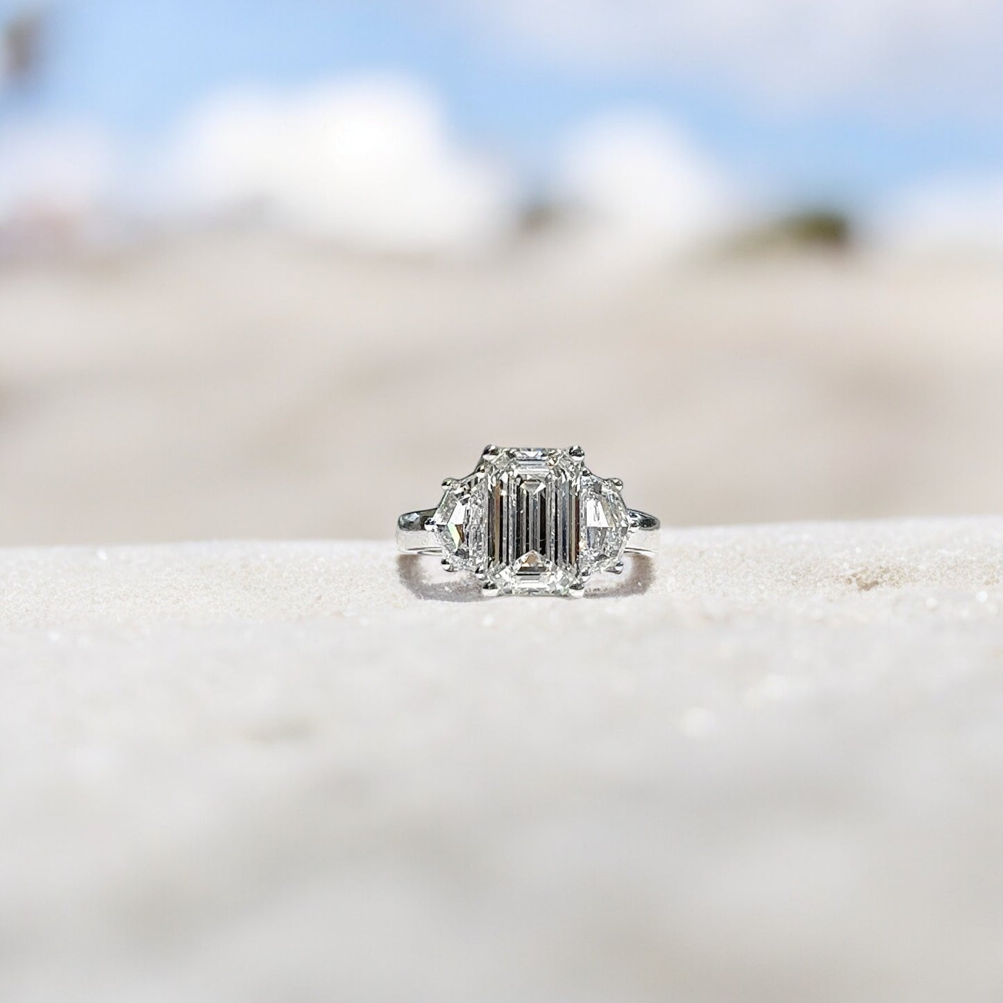 3.03 CT EMERALD CUT THREE STONE RING